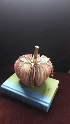 an apple sitting on top of two books