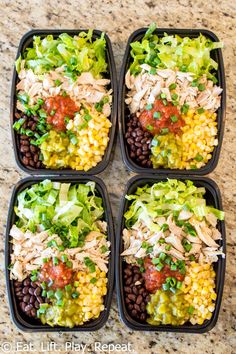 four plastic trays filled with different types of food