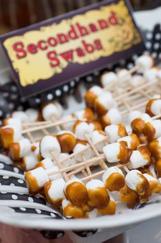 a plate with marshmallows on it and a sign that says secondhand swabs