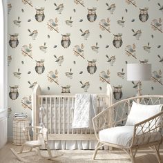 a baby's room with an owl wallpaper, rocking chair and crib