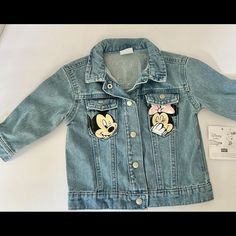 This Adorable Jean Jacket Is A Must-Have For Any Little Girl's Wardrobe. Featuring A Cute Minnie Mouse Character Design, This Denim Jacket Is Made Of High-Quality Cotton Material For Long-Lasting Comfort. The Jacket Has Long Sleeves And A Button Closure, Making It Perfect For Both Travel And Casual Occasions. The Blue Jacket Is Suitable For Girls Aged 6-9 Months And Has A Basic Style That Is Perfect For Any Season. The Lining Material Is Also Made Of Cotton, Ensuring That Your Baby Stays Cozy An Mickey Mouse Jean Jacket, Disney Denim Jacket, Mickey Mouse Denim Jacket, Disney Princess Denim Jacket, Toddler Disney Denim Jacket, Toddler Disney Jacket, Baby F, Disney Themed Outfits, Girls Wardrobe