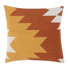 an orange and white pillow with arrows on the front, sitting against a white background