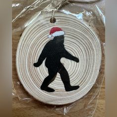 a christmas ornament with a silhouette of a man wearing a santa claus hat