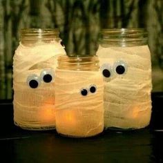 three mason jars with googly eyes on them