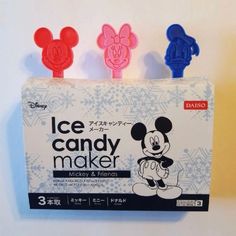 three mickey mouse ice candy maker molds in the package on a white surface with snowflakes behind them