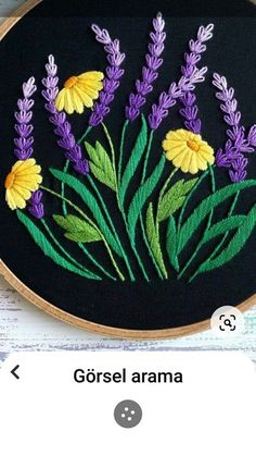 an embroidery project with flowers and leaves on it