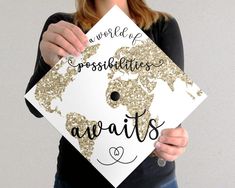 a woman holding up a graduation cap with the words congratulations awaits written on it