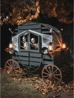 a horse drawn carriage with skeletons in it