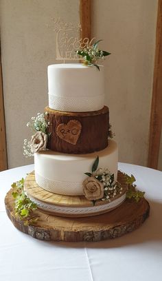 a three tiered wedding cake sitting on top of a table