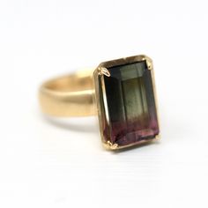 Fabulous Retro inspired hand-cast original design 14k yellow gold and genuine tourmaline ring! This custom piece was designed by Maejean Vintage specially to highlight the incredible 7.85 carat vintage bi-color watermelon tourmaline gemstone. The setting has a brushed, satiny finish overall with bright reflective accents. The prong set pink and green gem is framed by a polished halo that accents the gem beautifully. Gorgeous one-of-a-kind piece of fine jewelry! METAL / MATERIAL - 14k yellow gold Watermelon Tourmaline Ring, Green Gem, Jewelry Metal, Green Gems, Tourmaline Ring, Watermelon Tourmaline, Unisex Jewelry, Tourmaline Gemstone, Green Gemstones