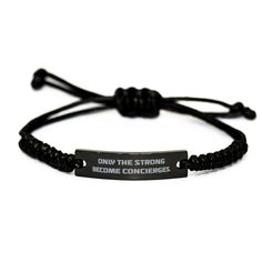 a black bracelet with the words, only the strong become concircles on it