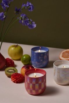 there are some fruit and candles on the table