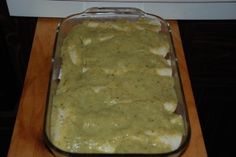 a casserole dish with green sauce in it