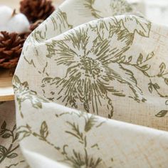 a table topped with napkins and pine cones