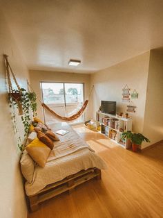 a bedroom with a hammock hanging from the ceiling