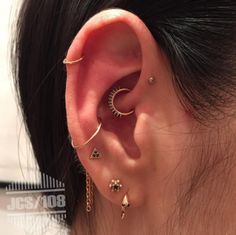 an ear with three different piercings attached to it