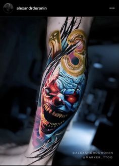 a person with a tattoo on their arm and leg is wearing an evil clown mask