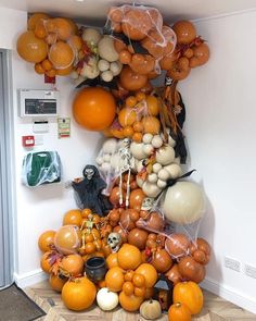 an arrangement of balloons and pumpkins in a room