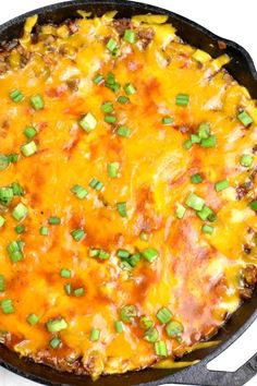 a skillet filled with cheese and green onions