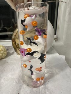 a glass vase with halloween decorations in it