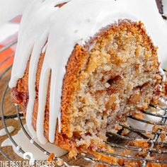 a bundt cake with white icing sitting on top of a metal wire rack