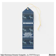 a blue christmas gift tag with reindeers and snowflakes on it, hanging from a string