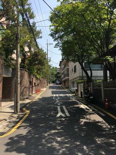 an empty street lined with trees and buildings