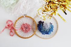 three different colored yarns are in a basket next to some scissors and streamers