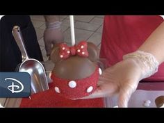 someone is decorating a minnie mouse cake