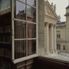 an old building with many books on the shelves in it's window sill