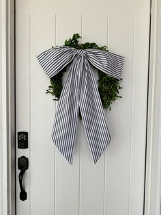 a white door with a black and white striped bow hanging on it's side