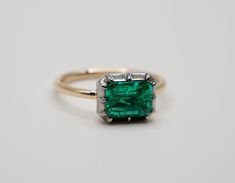 Lower prices on our main website: www.shopdiscomarshmallow.com The Georgian-Victorian Emerald Cut Emerald & Blackened Gold East West Button Back Collet Ring--a timeless engagement piece inspired by the grace of the Georgian and Victorian periods. This ring, featuring a stunning 2 ct lab-grown emerald in a Georgian cut-down collet setting and button back, exudes a timeless yet modern charm. It's not just an engagement ring; it's a versatile piece designed for stacking and layering with other styl East West Green Emerald Ring, Green Emerald Ring, Star Ring, East West, Natural Sapphire, Emerald Ring, Stackable Rings, Emerald Cut, Ring Verlobung