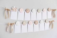 a white wall with wooden numbers and ribbons