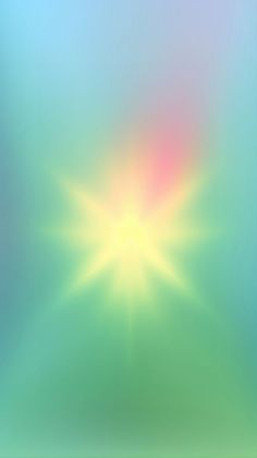 a blurry image of the sun shining brightly in blue, green and pink colors