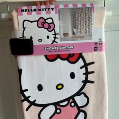 a hello kitty towel hanging on a door with the tag in it's pocket