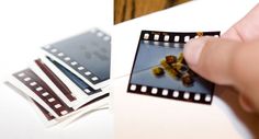 a hand is holding a film strip and taking pictures