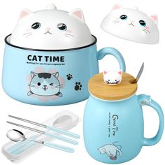 a cat mug with spoons and utensils next to it