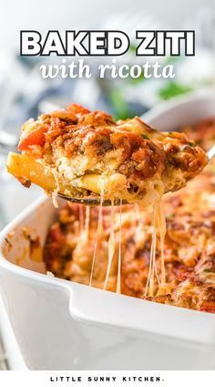 baked ziti with ricotta in a white casserole dish being lifted from a serving spoon