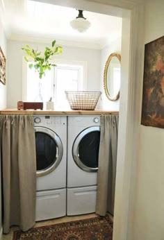 a washer and dryer sitting in a room next to each other on top of a rug