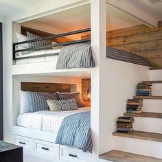 bunk beds are built into the side of each other in this small room with stairs leading up to them