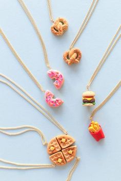 several necklaces with different types of food on them and one has a hot dog