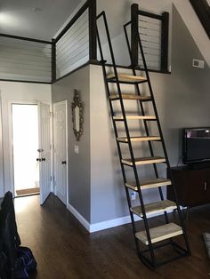 there is a ladder in the corner of this room that leads up to the loft