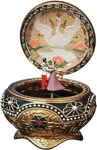 an elaborately decorated trinket with a figurine in it