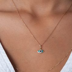 "Our evil eye charm is made of solid 14k gold, inlaid with 0.05 ctw white diamonds and filled with turquoise enamel. The evil eye is a symbol for good luck and safekeeping. Details: 14k solid rose gold evil eye charm measuring 12mm 5pts genuine white diamonds 0.05ctw 14k solid gold delicate cable chain and clasp measures 16 inches If you have any questions about this bracelet, just hit the \"Ask a Question\" button next to the price and we will get back to you within 24 hours. Thanks for shoppin 14k Gold Evil Eye Pendant Charm Necklace, 14k Yellow Gold Evil Eye Charm Necklace, Dainty 14k Gold Charm Necklace With Evil Eye, 14k Gold Evil Eye Charm Necklace With Round Pendant, Evil Eye Amulet, Eye Pendant Necklace, Silk Bracelet, Evil Eye Necklace Gold, Diamond Evil Eye