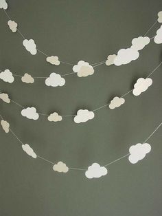 paper clouds and stars are hanging on the wall next to a photo of a cloud garland