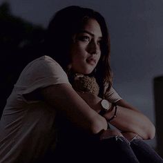 a woman sitting on the floor with her arms crossed