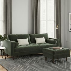 a living room scene with focus on the couch and ottoman