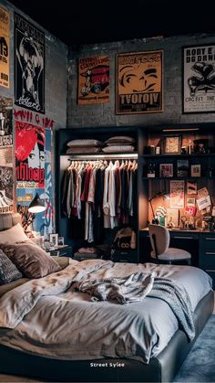 a bed sitting in a bedroom next to a wall with posters on it's walls