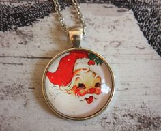 "Christmas pendant necklace featuring a a super sweet Santa Clause image. The image is under glass and the setting is antiqued silver-tone metal. The pendant is attached to a 24\" chain with lobster claw closure. Pendant is 25mm or about 1\" in diameter. Thank you for looking at my item!" Retro Necklaces With Lobster Clasp For Gifts, Retro Necklaces With Lobster Clasp As A Gift, Retro Necklace With Lobster Clasp As Gift, Vintage Christmas Gift Necklaces, Vintage Necklaces For Christmas Gifts, Vintage Necklace For Christmas Gift, Retro Nickel-free Necklaces For Gifts, Retro Nickel-free Necklace For Gift, Retro Nickel Free Necklace For Gift