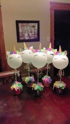 balloons with unicorn heads and flowers in them